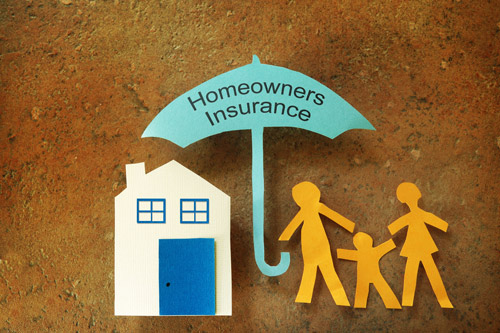 Image of paper house with umbrella saying Homeowners Insurance and stick figure family