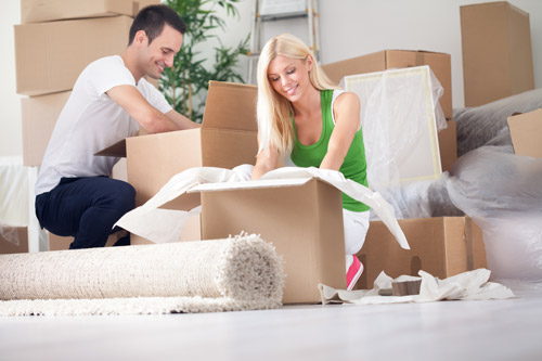 Image of couple packing boxes to move
