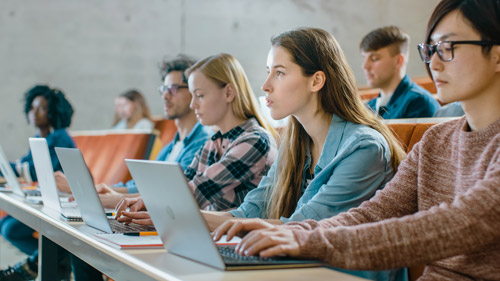 Image of High School students sitting in classroom with laptops