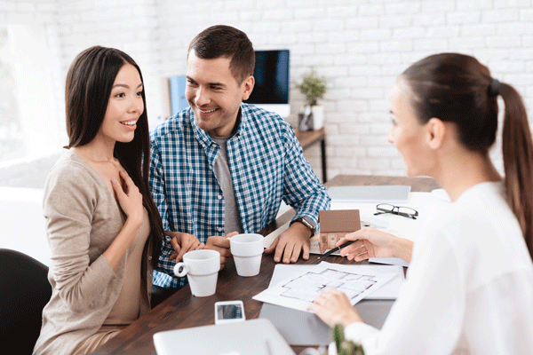 Sellers seated at table with agent