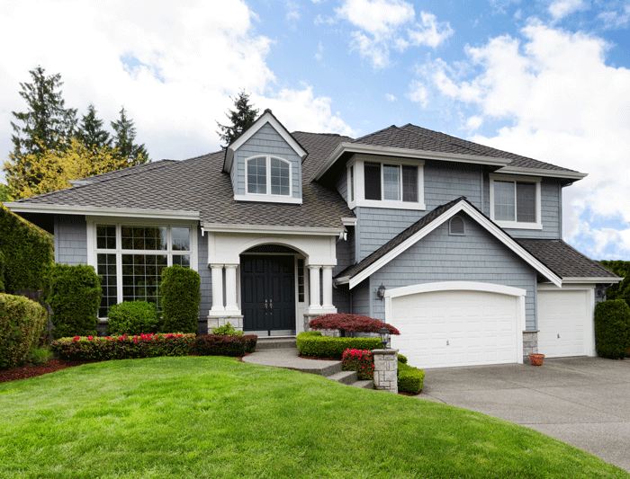 Home with gray siding and 2 car garage with green front yard