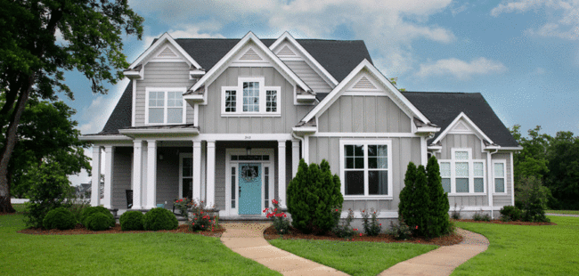 gray two story house with blue front door