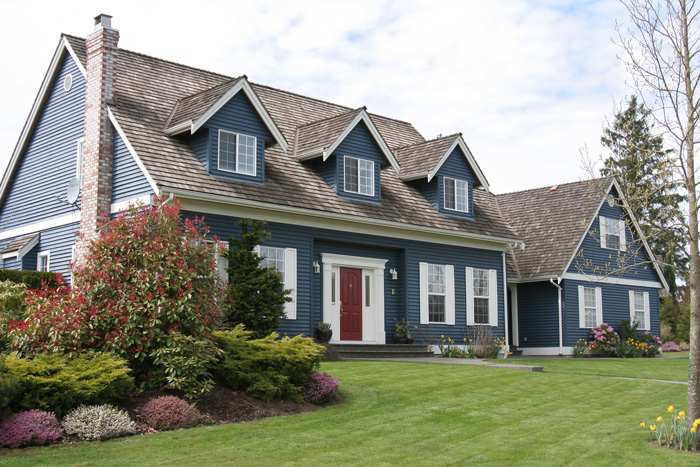 Gray House one & half story with 3 dormer windows and red front door